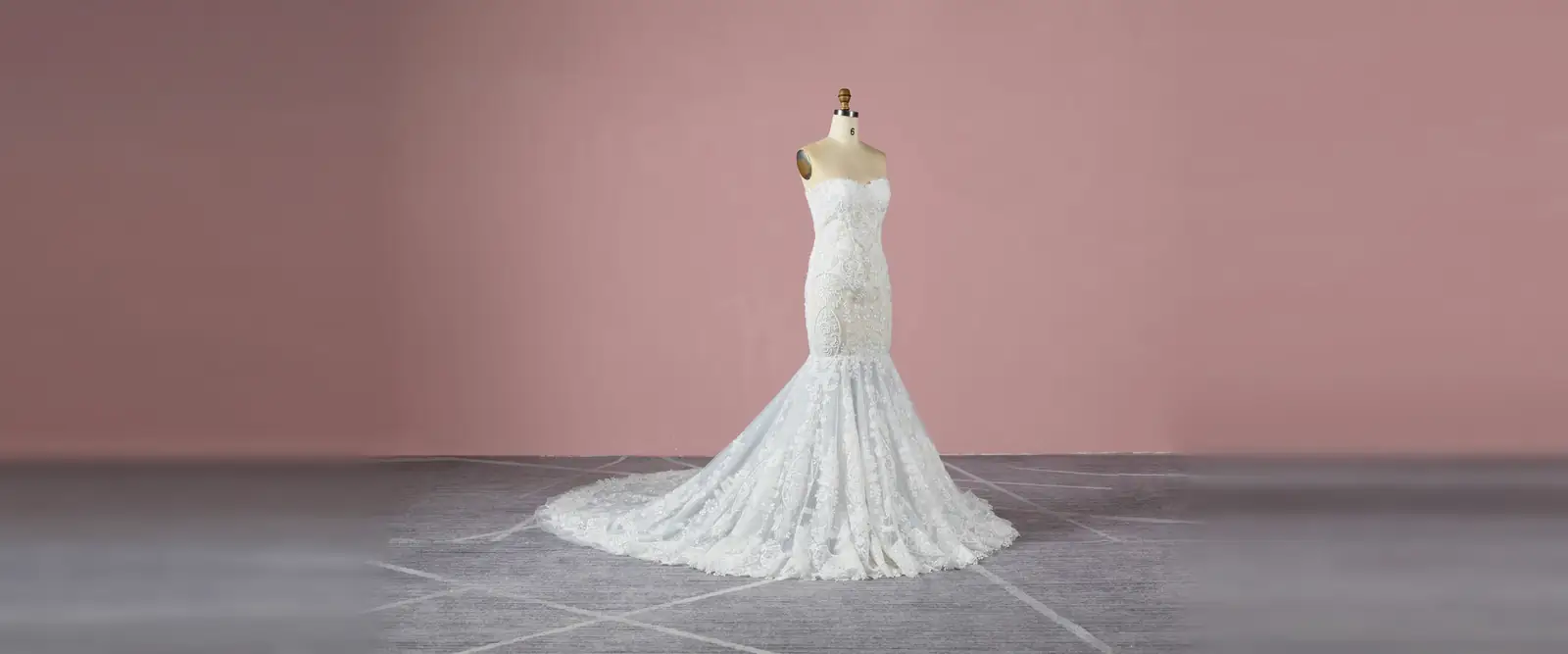 A lace mermaid wedding gown on a dress form